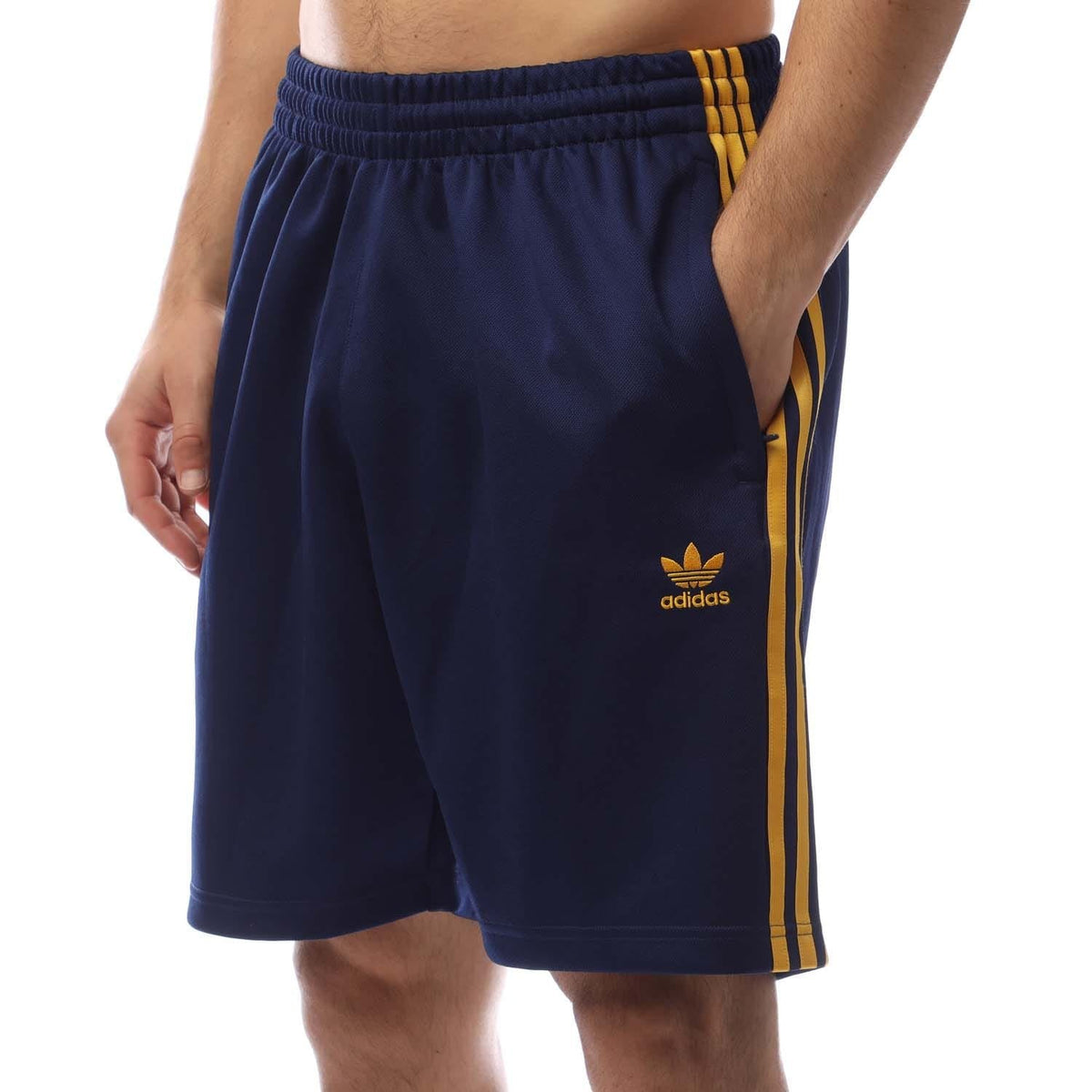 Navy adidas track shorts with elastic waistband, yellow side stripe and small logo