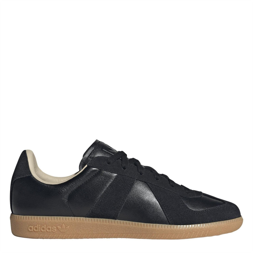 Black adidas Originals low-top sneakers with lace-up front, panel stripes, and gum sole