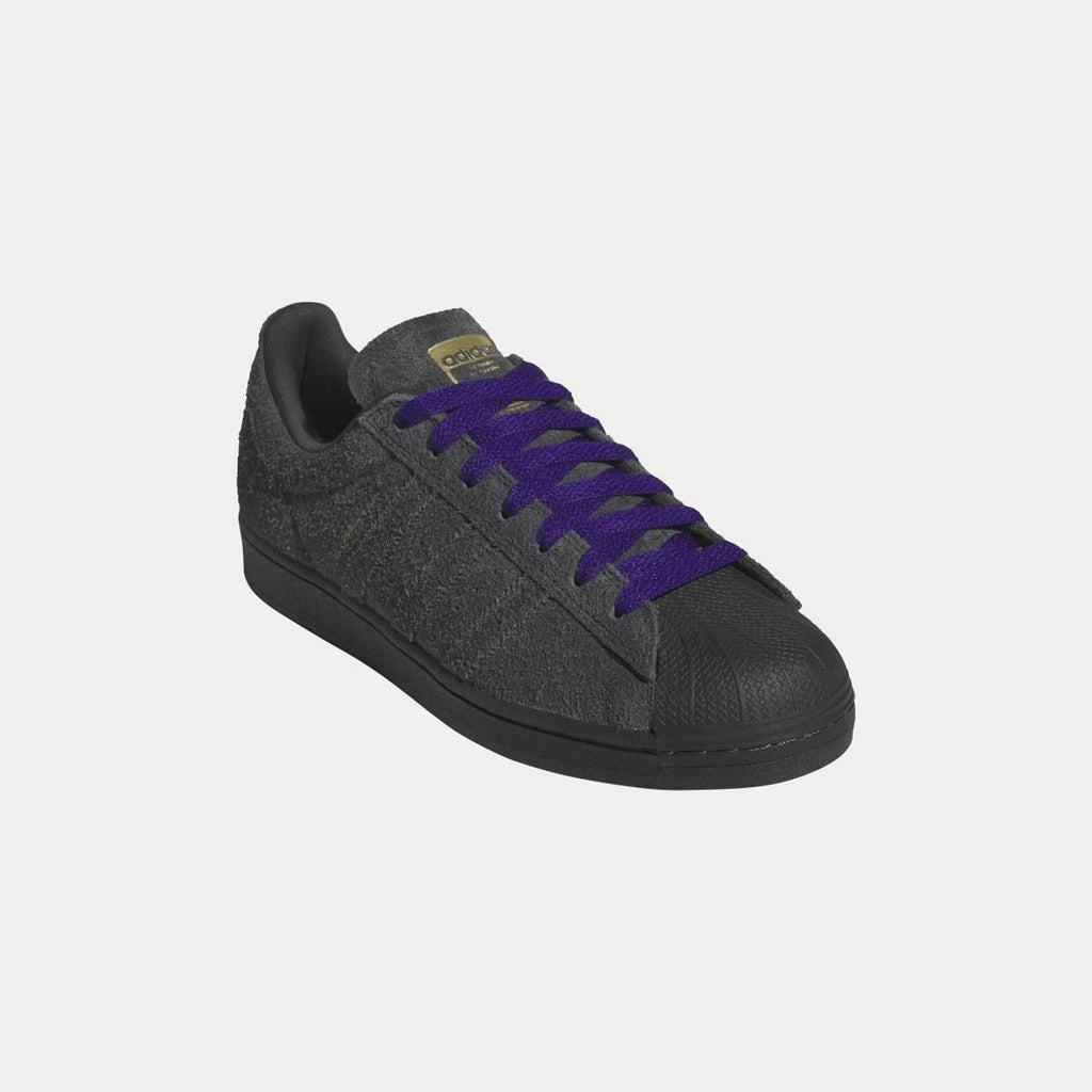 Black low-top Adidas Originals sneaker with purple laces and textured finish