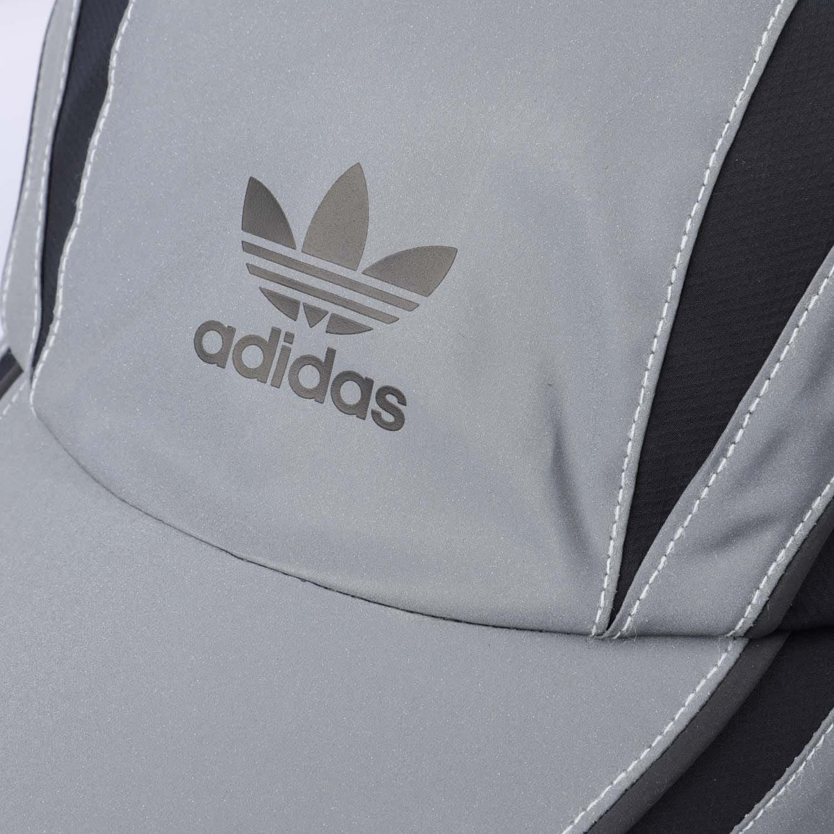 Silver gray front panel with adidas trefoil logo and contrast black side