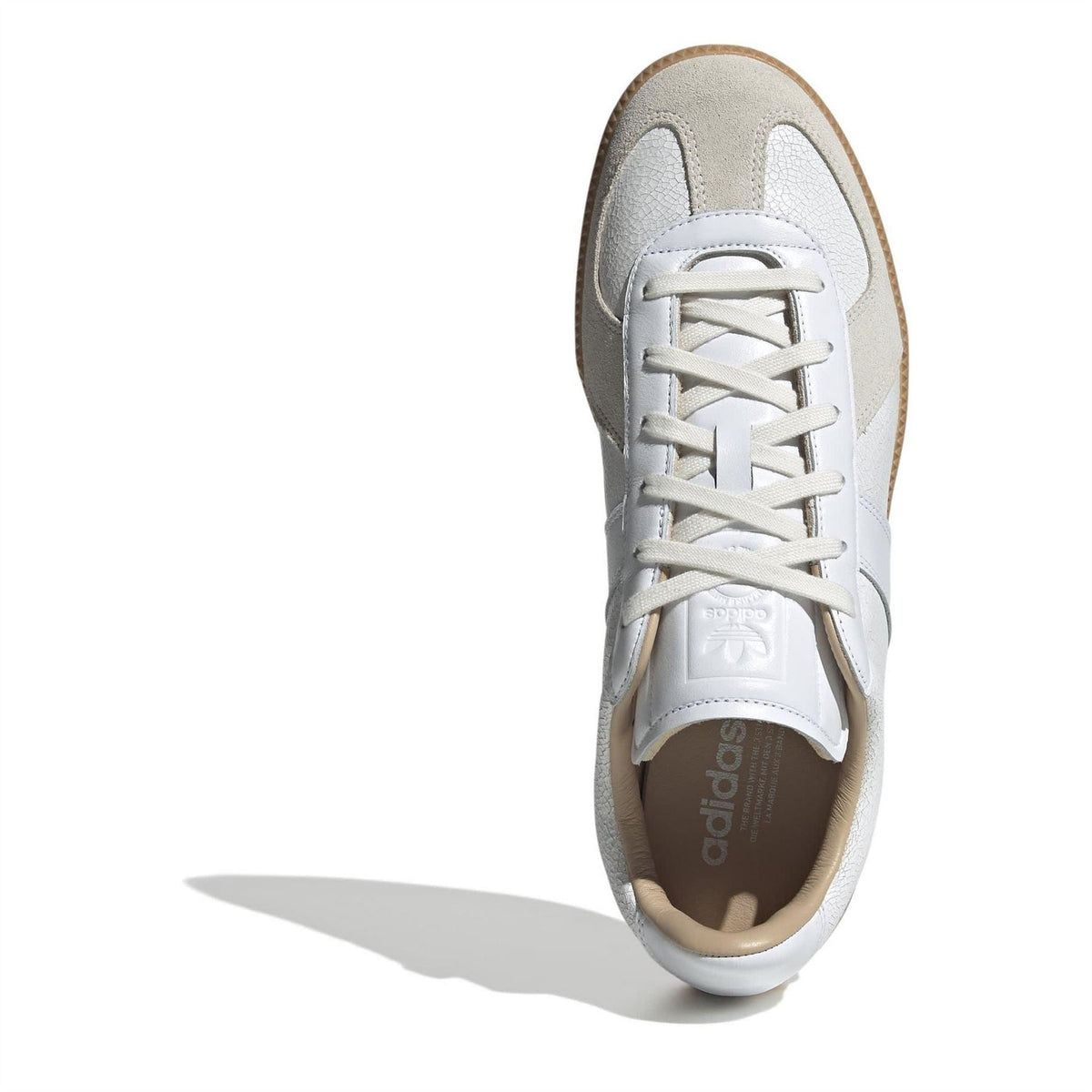 Single adidas sneaker viewed from front: white leather upper with beige collar and gum outsole