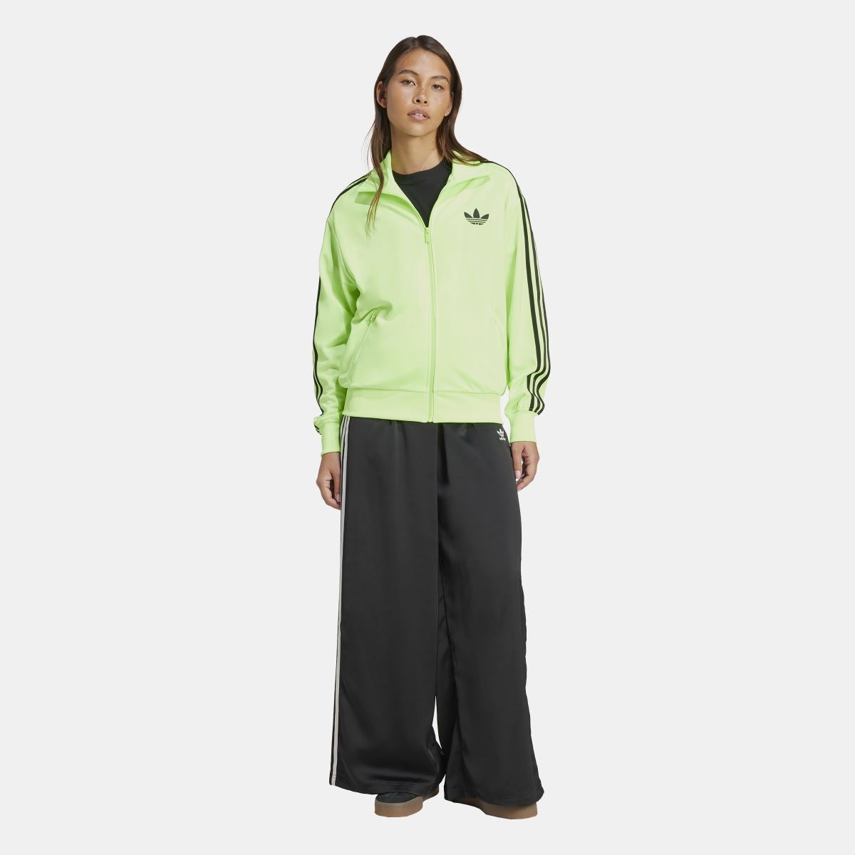 Lime green zip-up track top with black trefoil logo and side stripe detailing