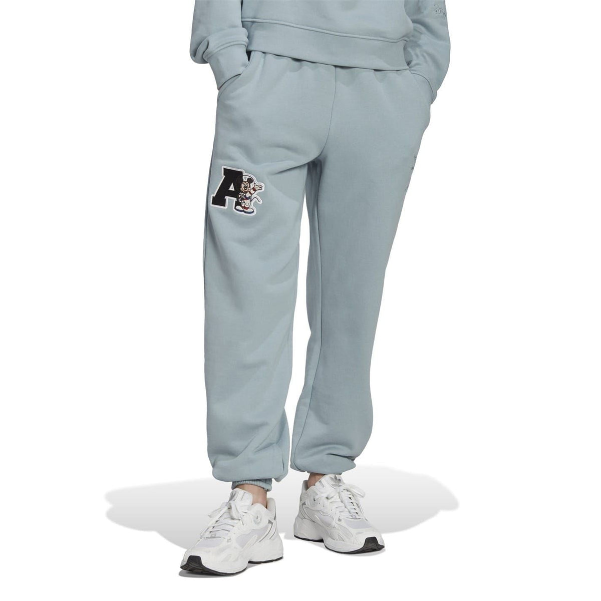 Grey track joggers with elastic cuffs and Mickey Mouse patch on the thigh
