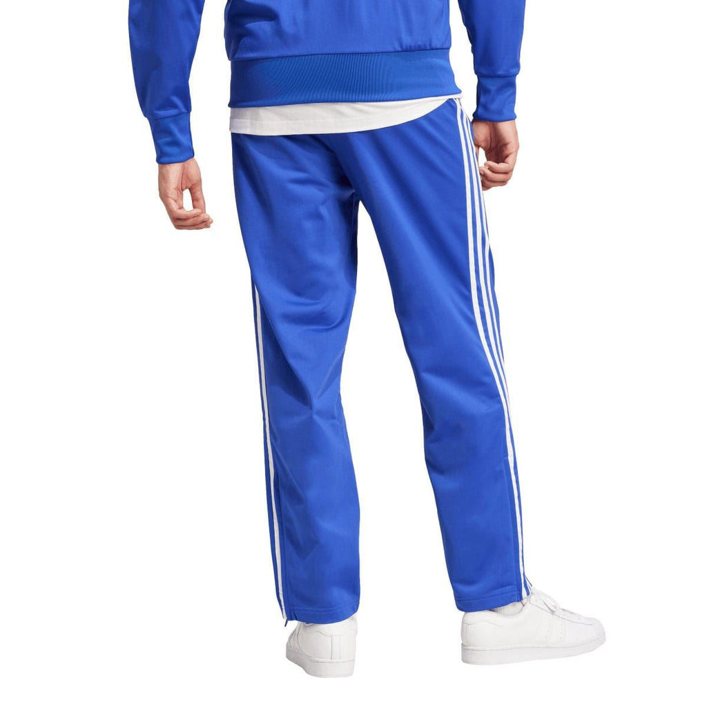 Blue track pants with white side stripes and ribbed ankle cuffs
