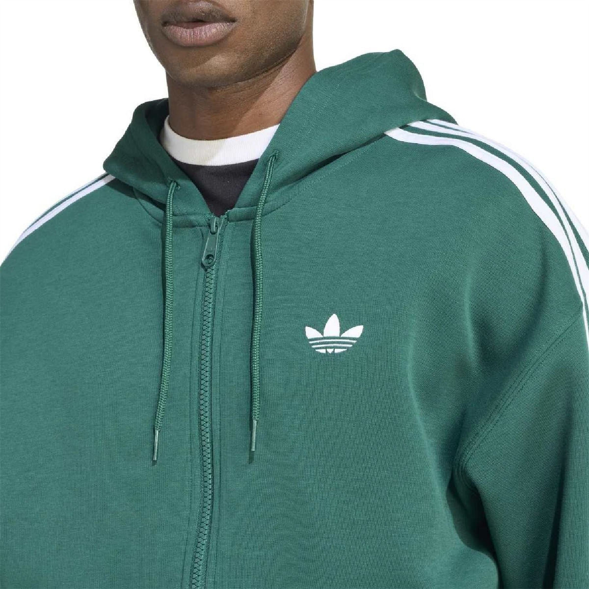 Close-up of green zip hooded sweatshirt with trefoil logo and drawstring hood