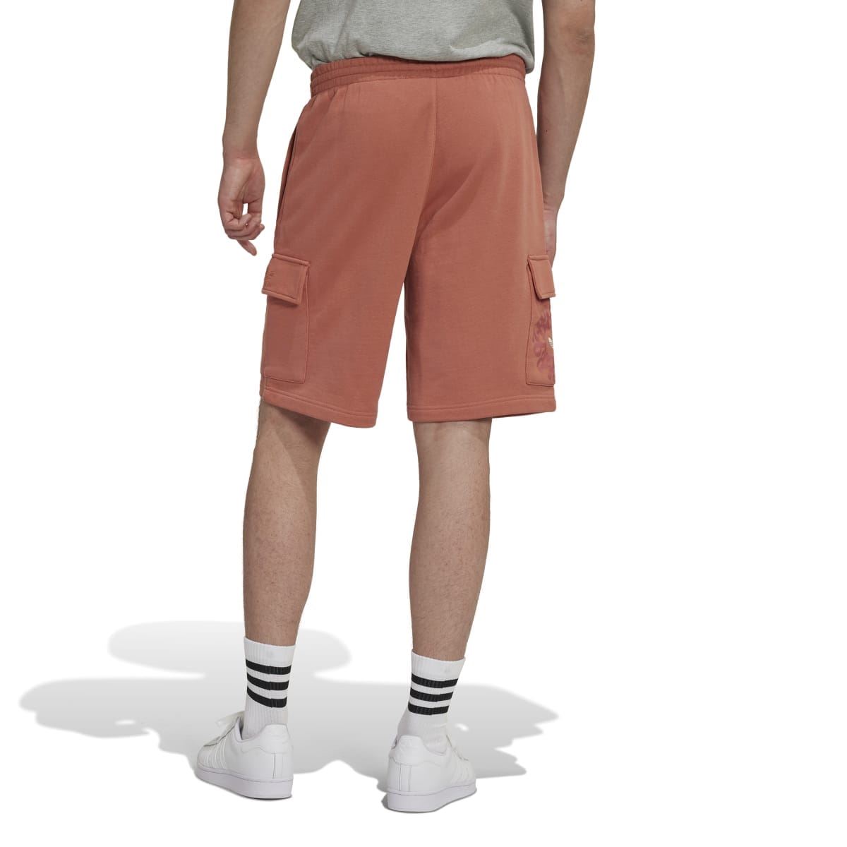 Rust-brown cargo shorts with elastic waistband and side flap pockets, rear view