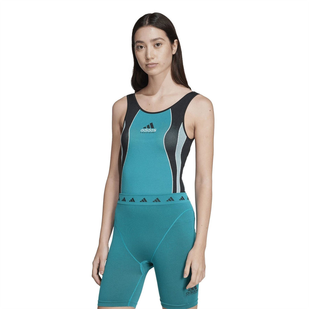 Teal athletic one-piece swimsuit with black side panels, adidas logo, and patterned waistband