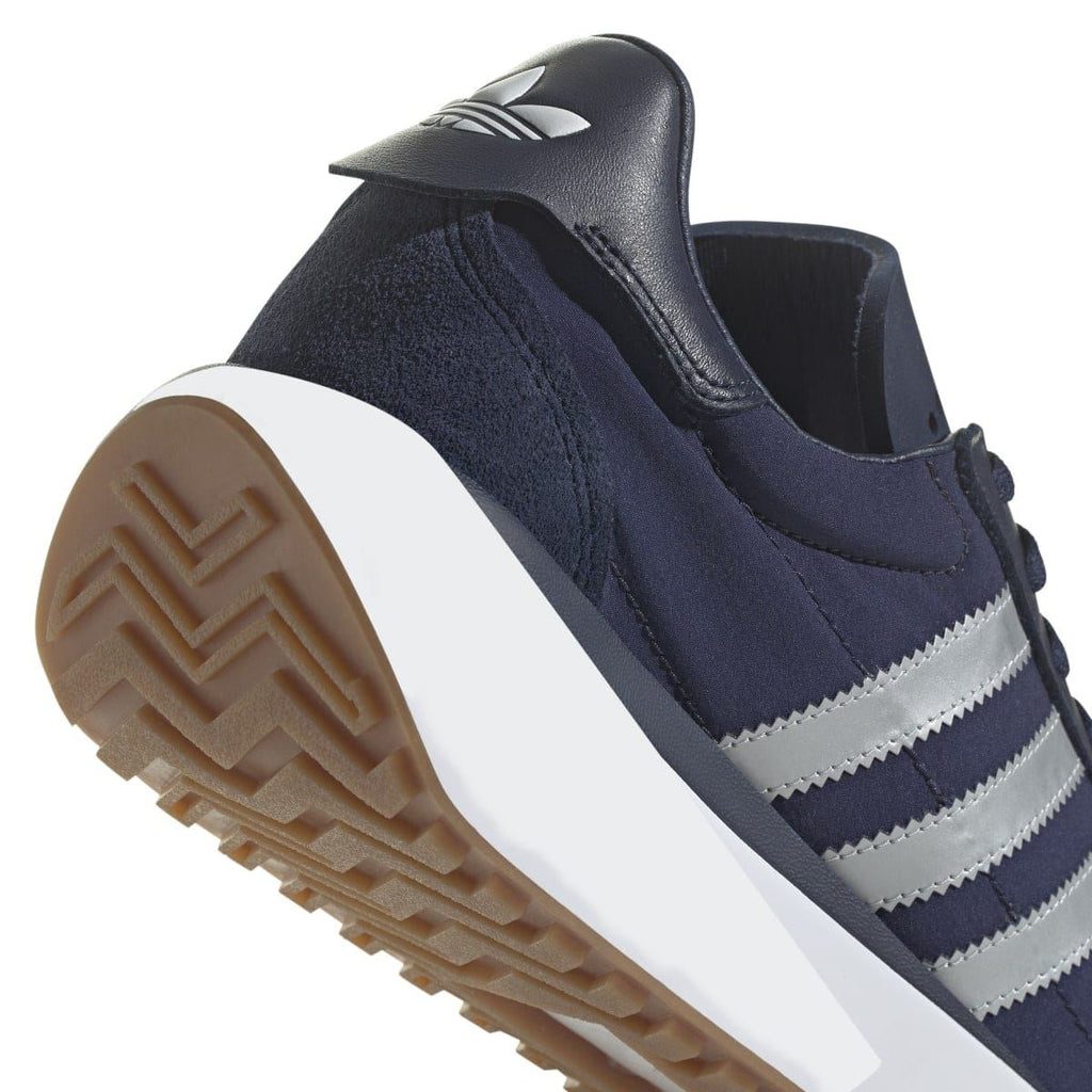 adidas Originals Courty XLG heel side view with navy suede and white stripe trim