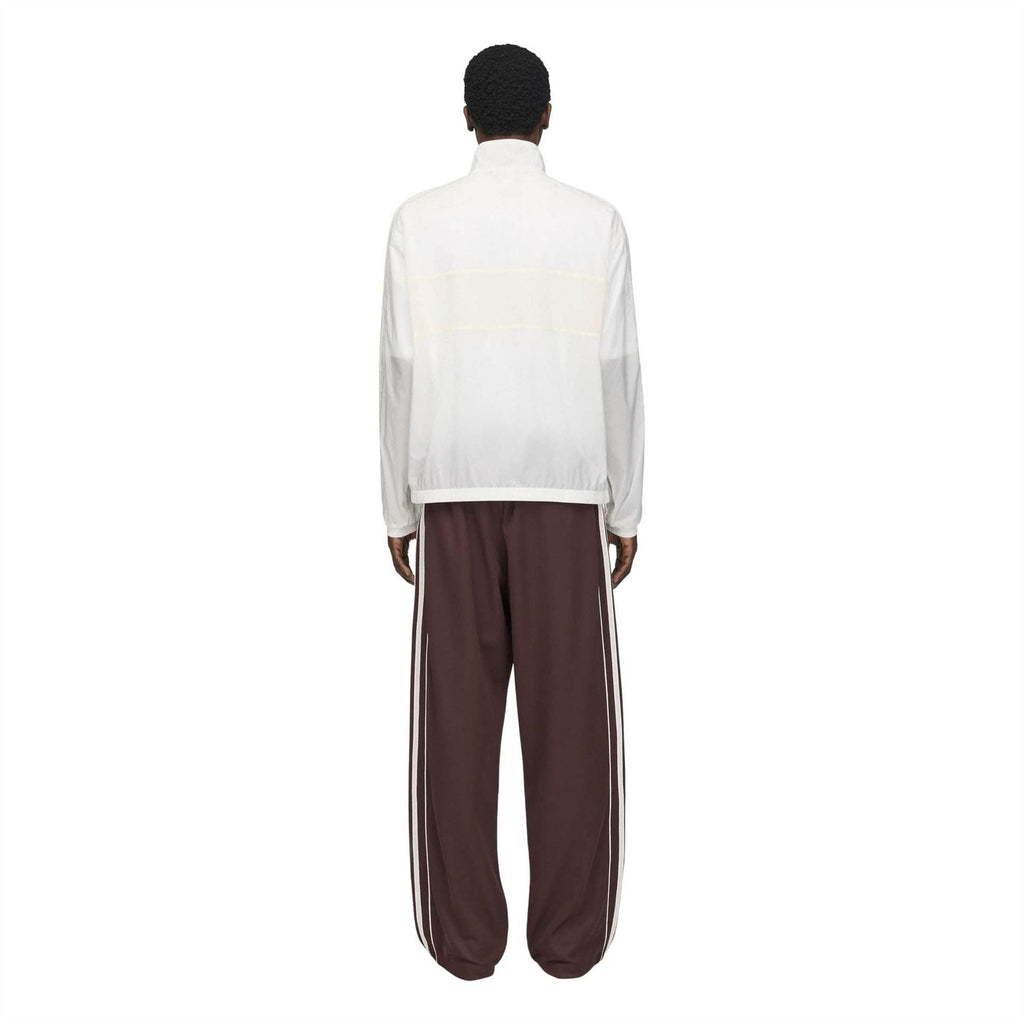 Chalk white track jacket back with stand collar, full-coverage paneling, elastic cuffs.