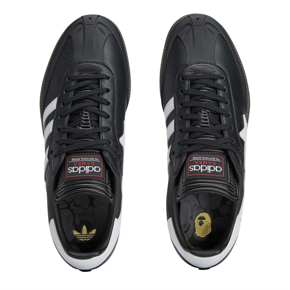 Black low-top sneakers with black laces, white side stripes, and branded insoles