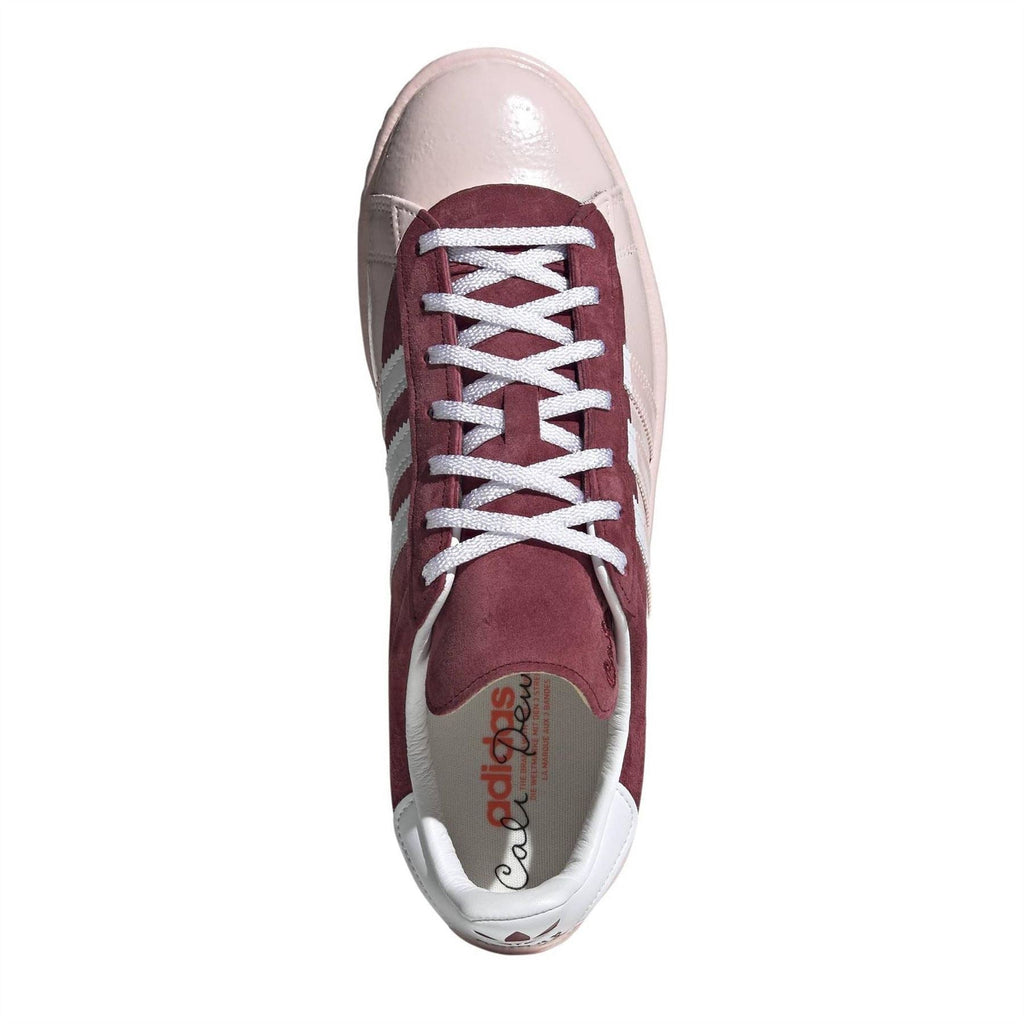 Top view of burgundy-and-off-white lace-up trainers with white adidas-style branding