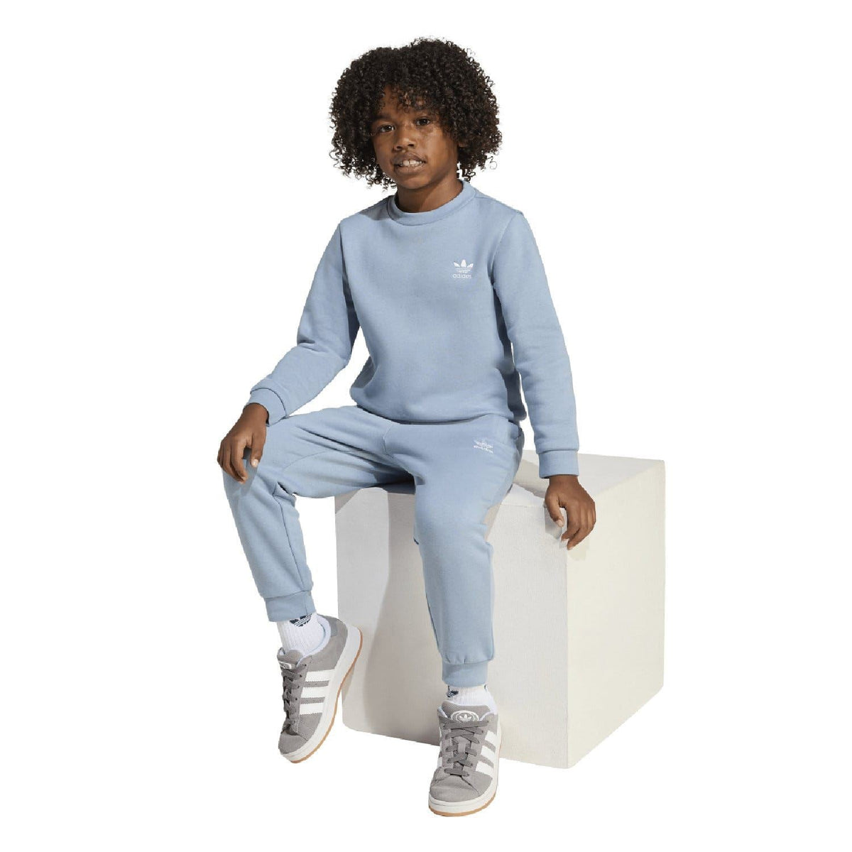 Light blue infant adidas Originals tracksuit set with crew sweatshirt and joggers.