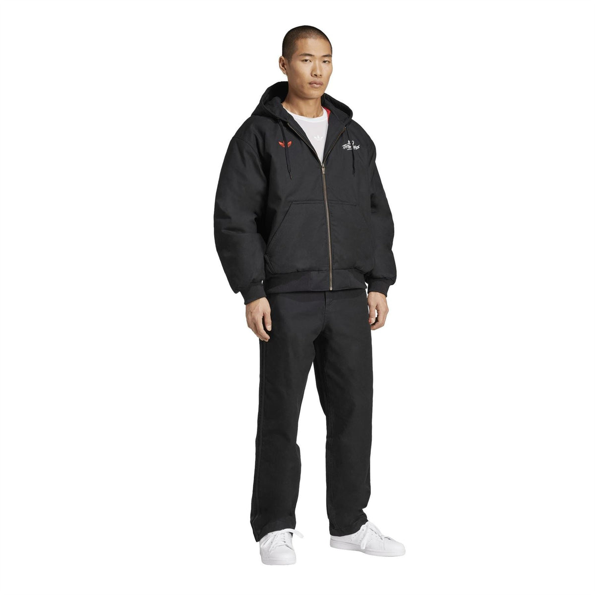adidas Originals 100T black pants worn with a black jacket and white sneakers
