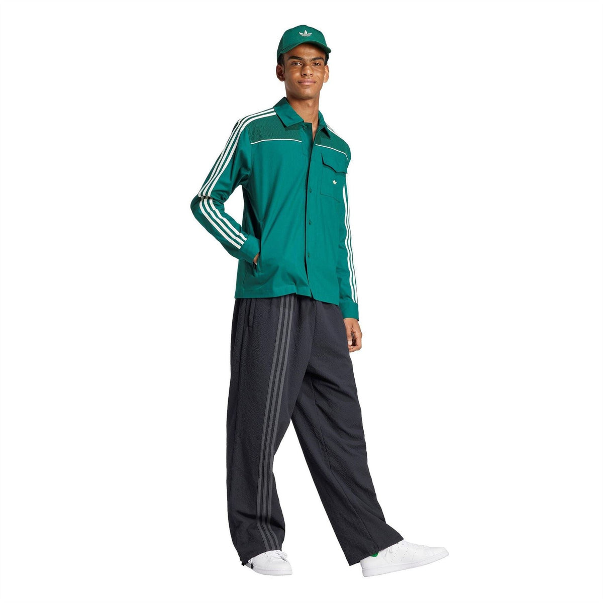 Green jacket on model with stand collar and white triple sleeve stripes, buttoned front