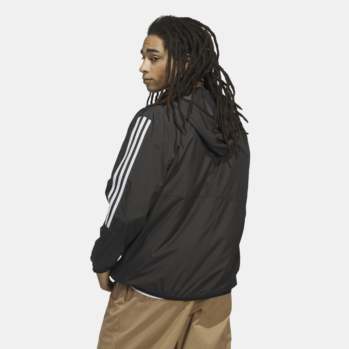 Black windbreaker jacket with white three-stripe sleeve accents and zip front