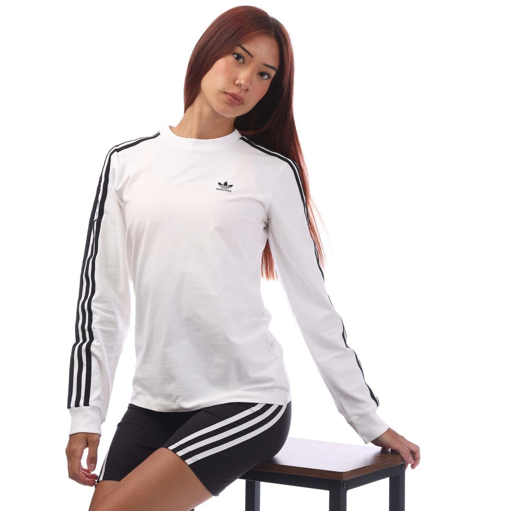 White long-sleeve top with black 3-stripe shoulders and chest trefoil logo