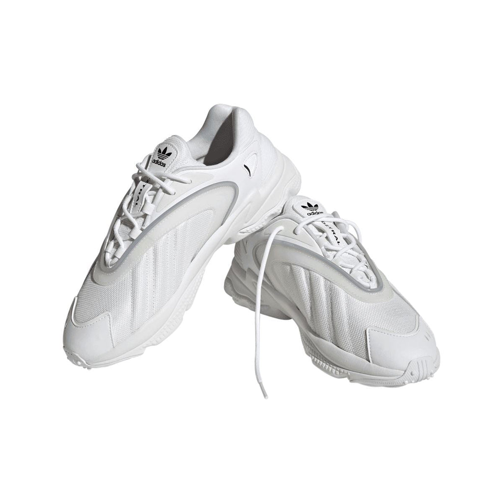 White adidas Originals Oztral trainers, angled view with laces and woven-look upper