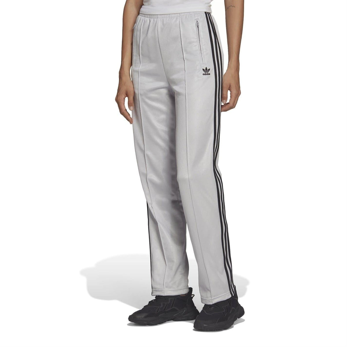 Light gray adidas Originals sweatpants with black side stripes and trefoil logo