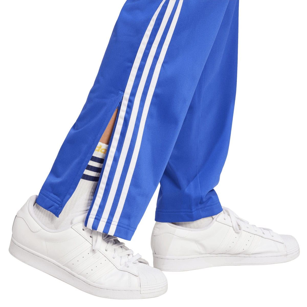 Blue track pants leg with white triple stripe detailing and side seam