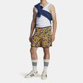 Floral knit shorts with black base, yellow orange flowers, and vertical side stripe