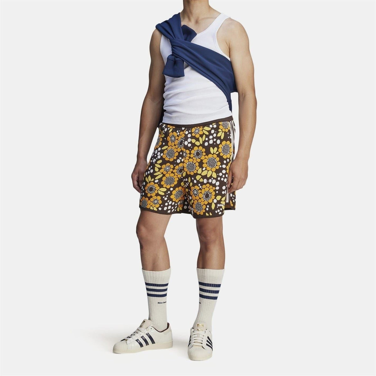 Floral knit shorts with black base, yellow orange flowers, and vertical side stripe