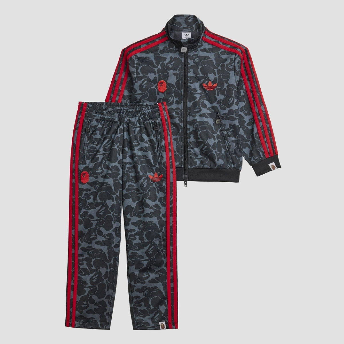 Kids camo tracksuit jacket with red zip, triple sleeve stripes, and ribbed cuffs