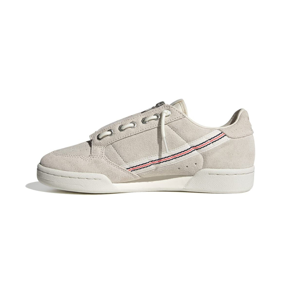 Light beige suede low-top trainers with lace-up closure and red/blue stripe side detail