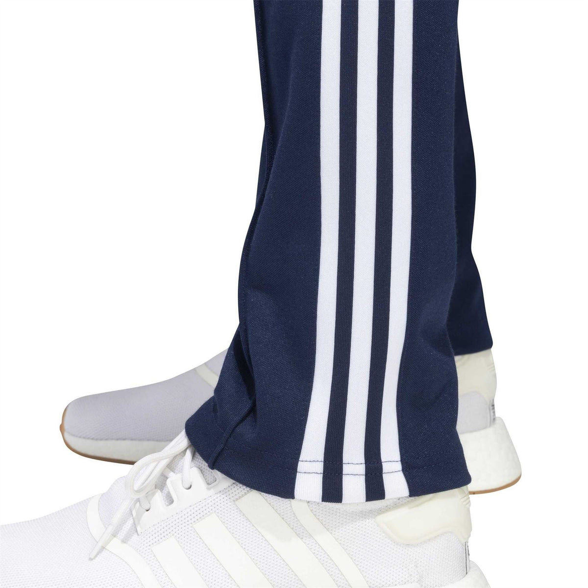 adidas track pants lower leg: navy with three white stripe lines and tapered cuff