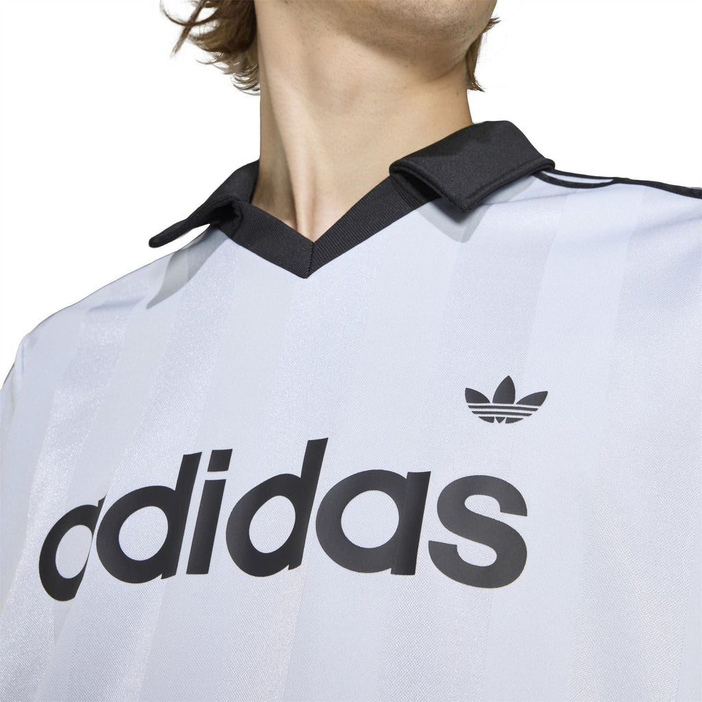 Light blue adidas polo shirt neckline detail with black collar and trefoil logo