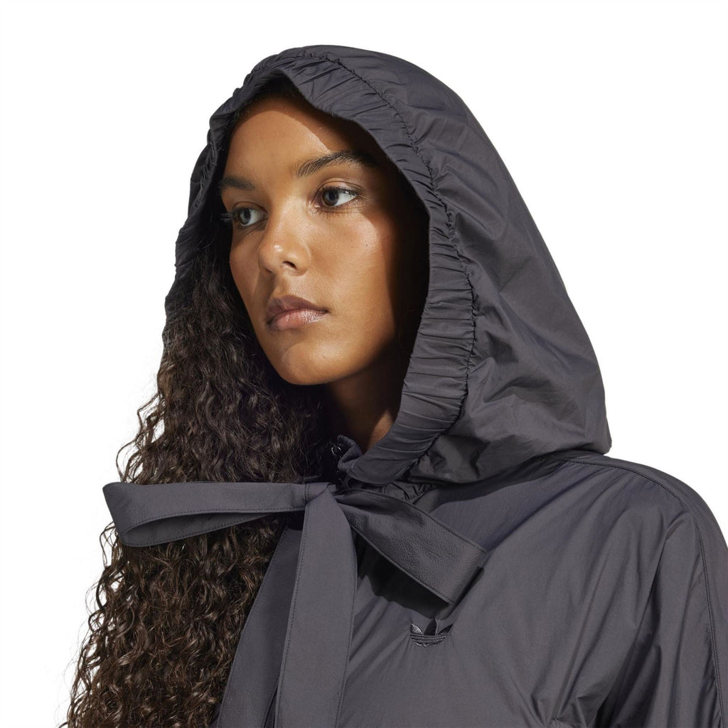 Black hooded bomber jacket with draped hood and bow tie at collar