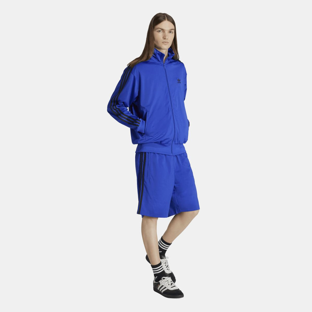 Blue adidas track jacket with full zip and matching blue drawcord at hem