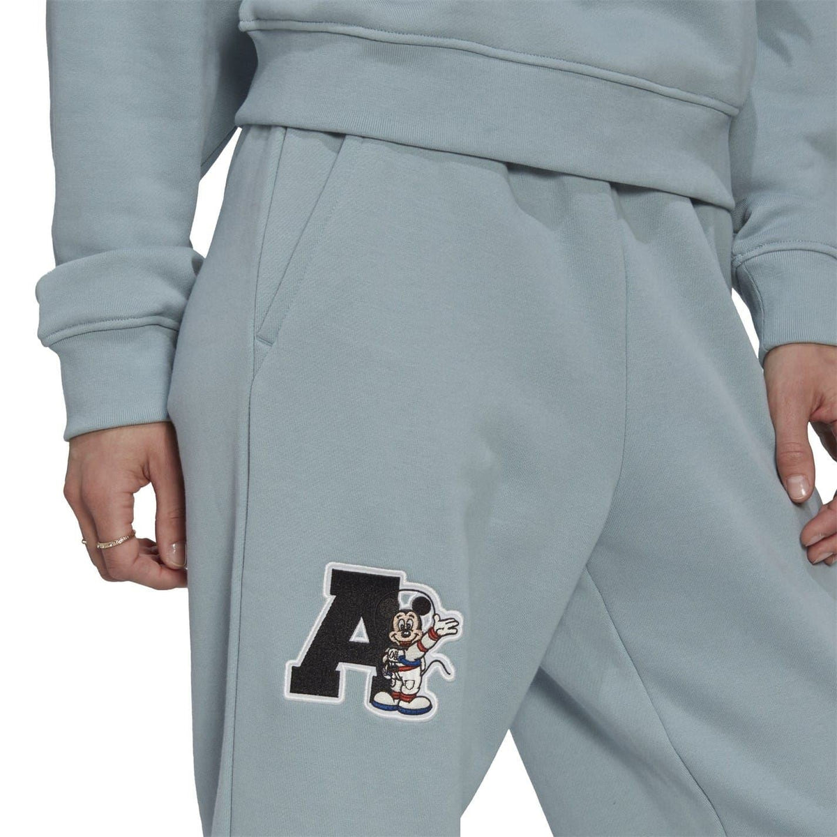 Light grey joggers with Mickey Mouse “A” patch on the thigh
