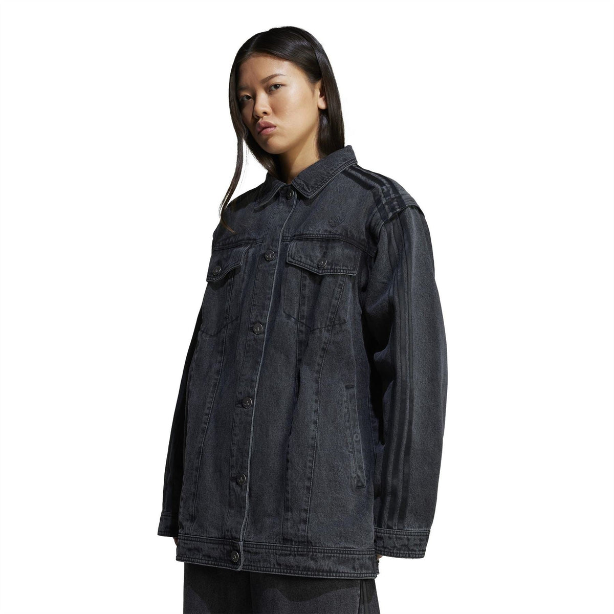 Black denim shirt jacket worn on model, button front and flap chest pockets