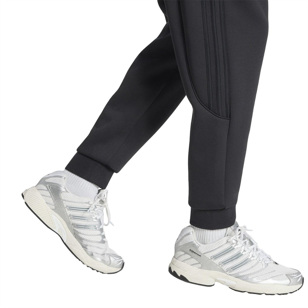 Black track pants with tapered ankle, smooth side panel stripes and trefoil logo