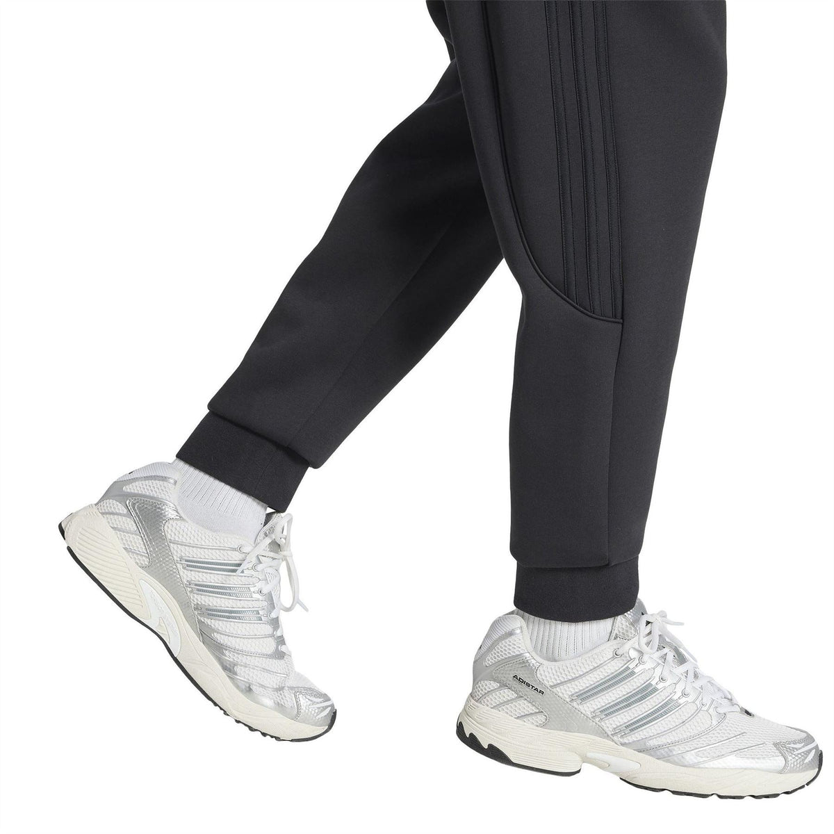 Black track pants with tapered ankle, smooth side panel stripes and trefoil logo