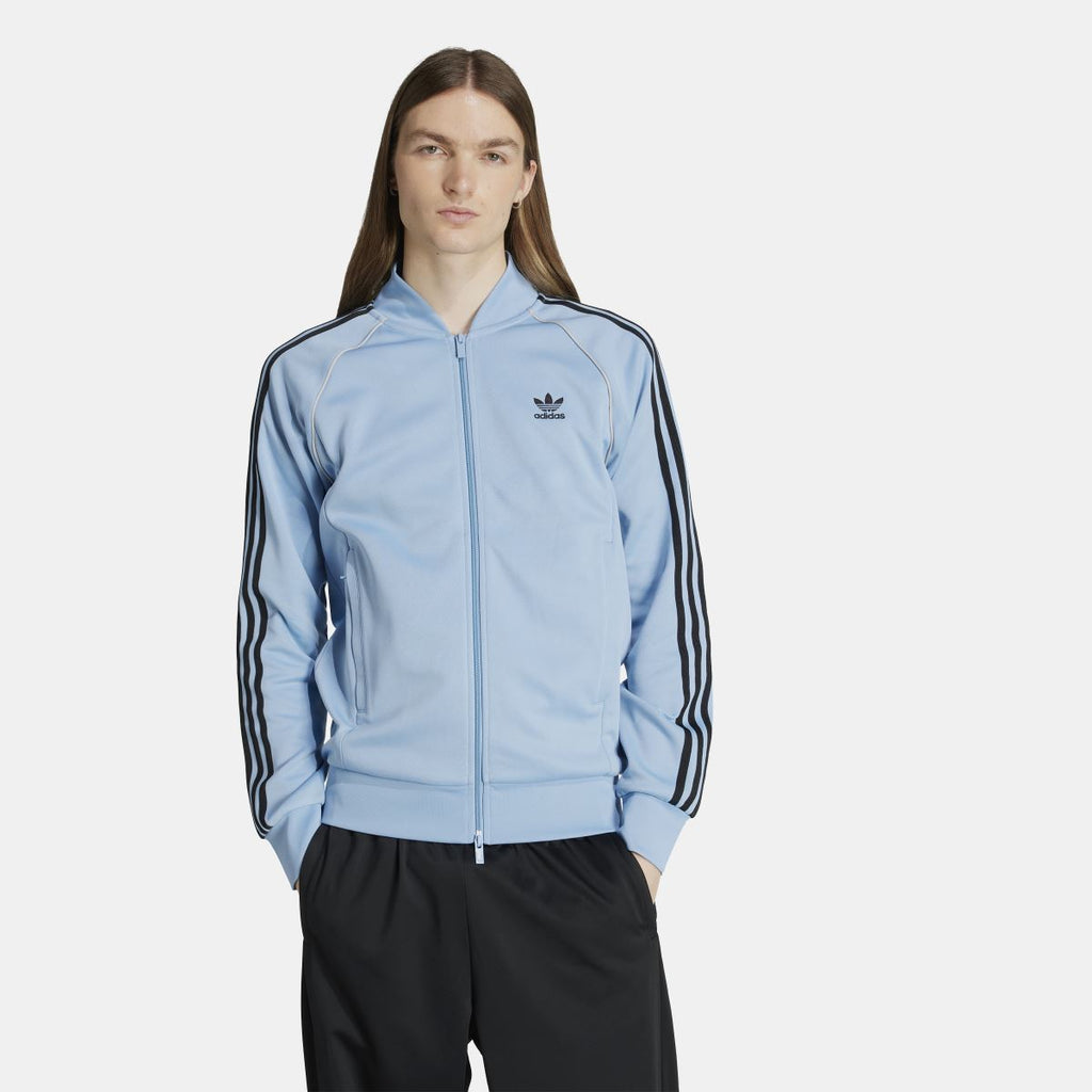 adidas Originals Adicolor Classic SST track jacket in blue with white stripes, featuring a zip-up front and stand collar.