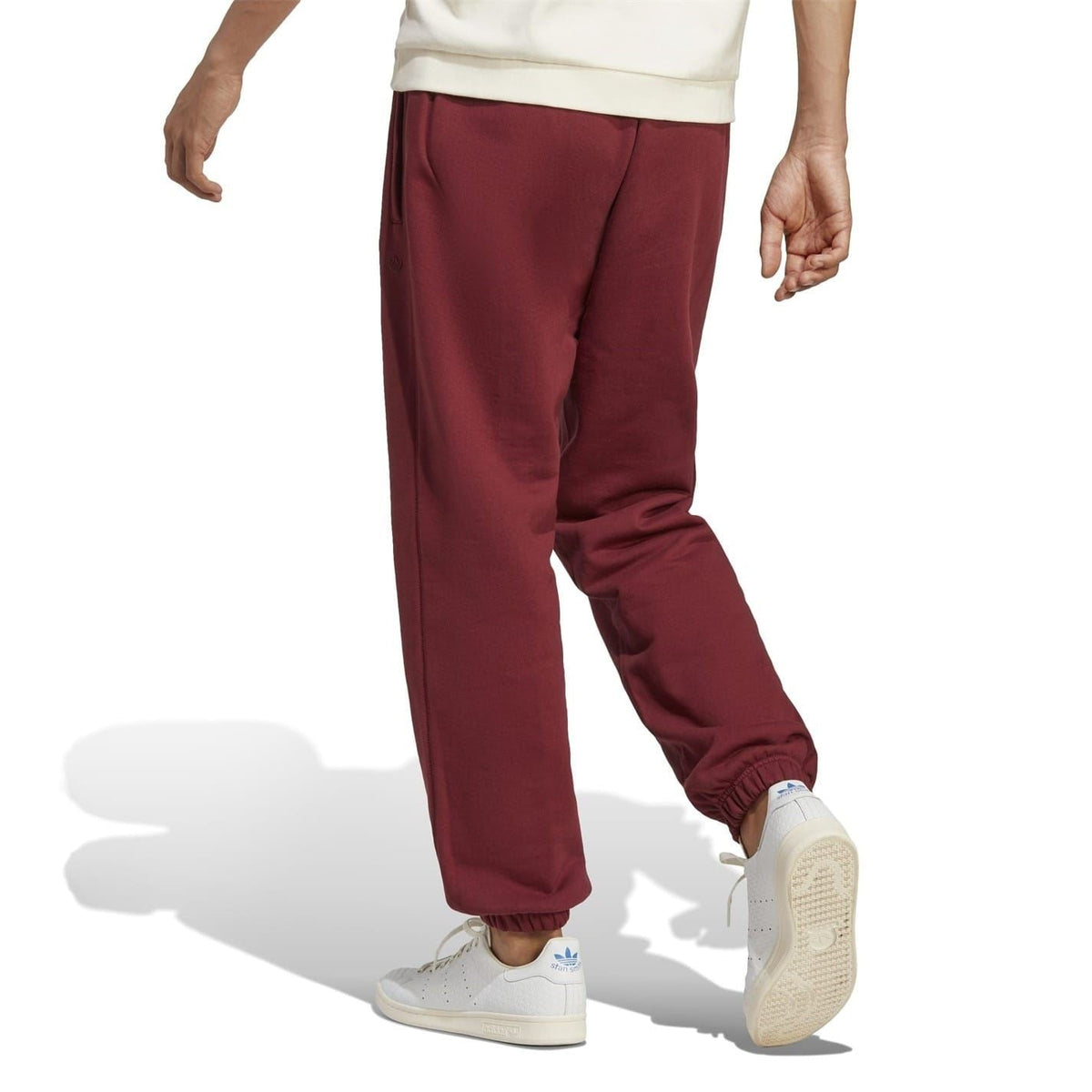 Burgundy tapered jogger pants with side pockets and elastic ankle cuffs