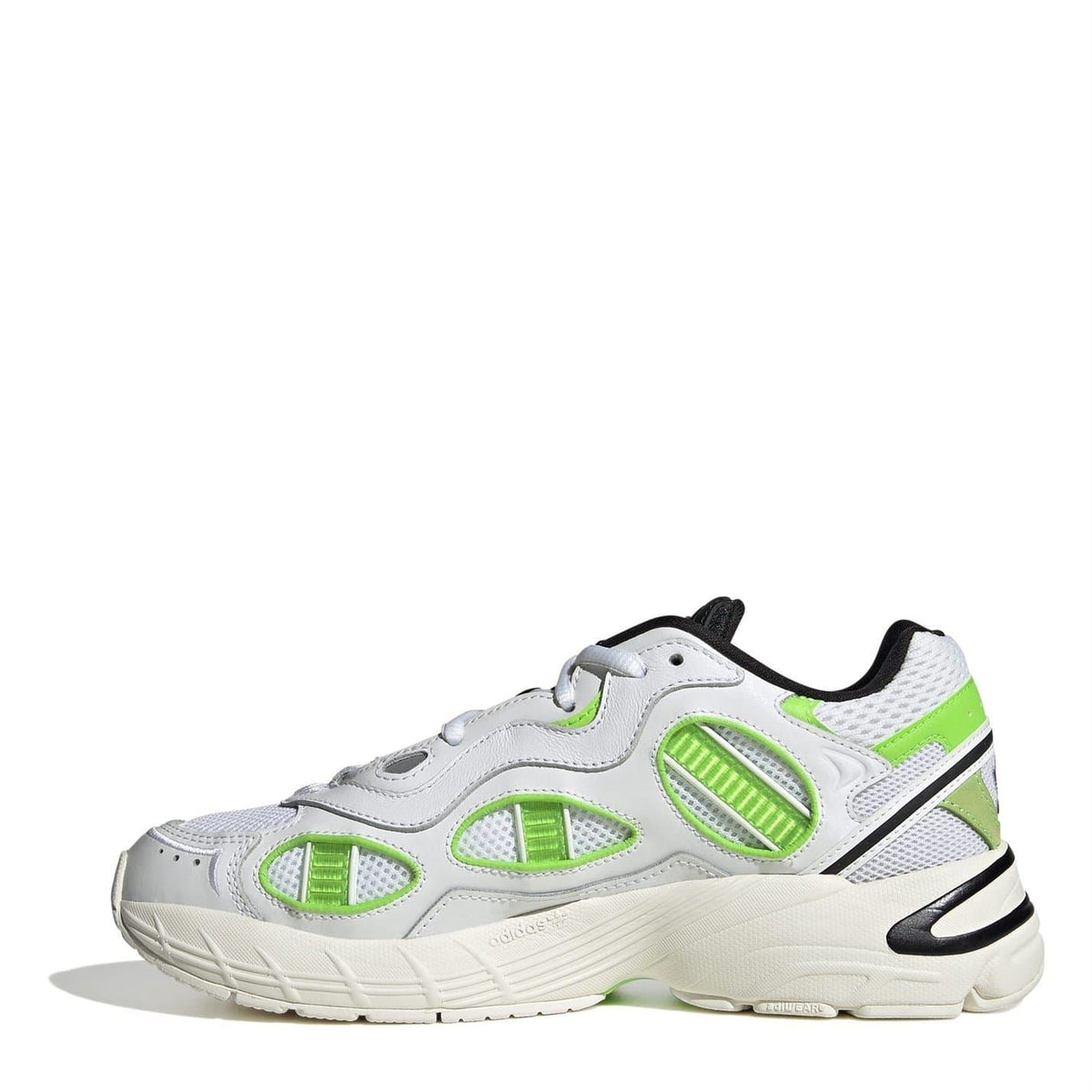 Side view of white low-top sneakers with neon green overlays and sculpted midsole