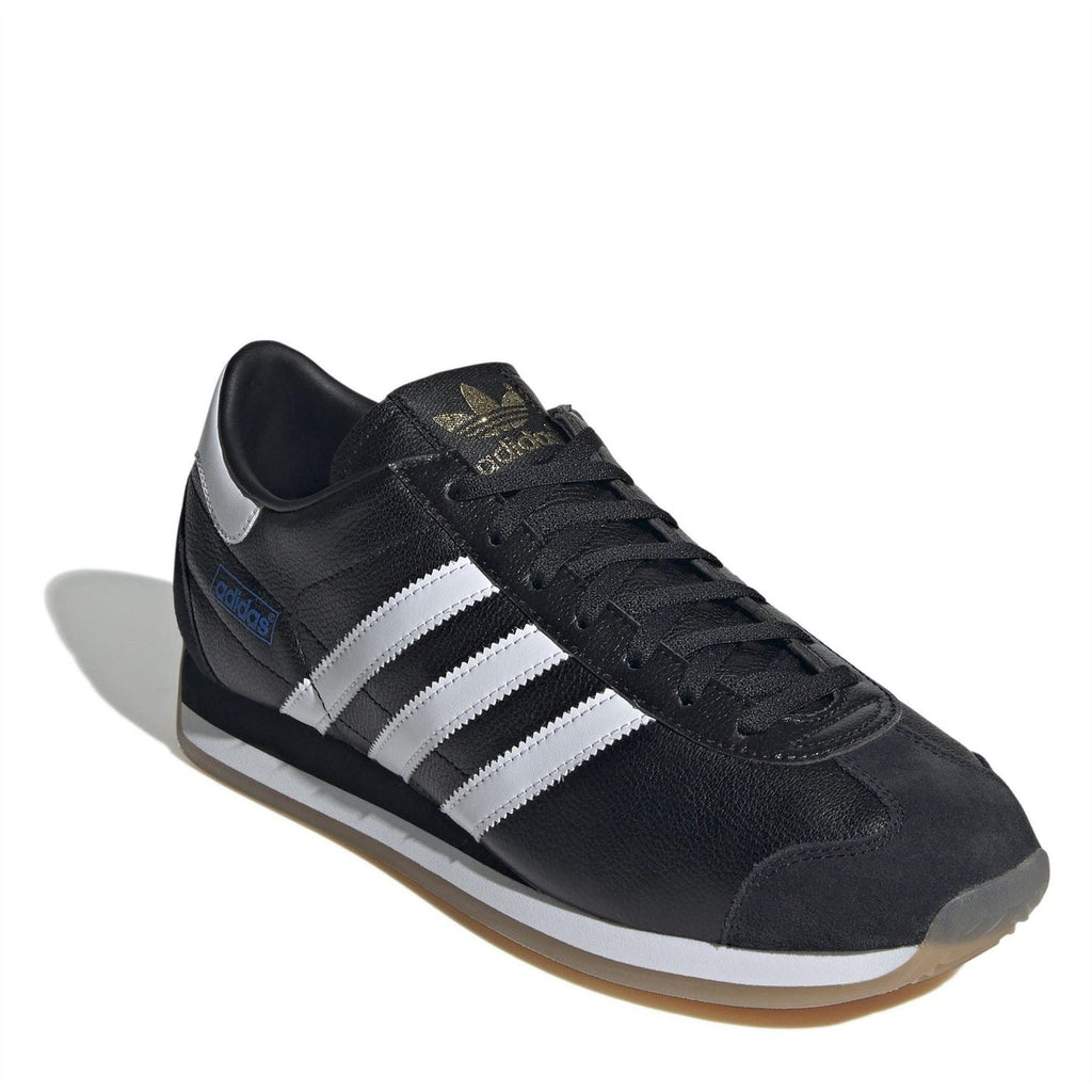 Black leather adidas sneakers with white stripes, lace-up design, stitched overlays.