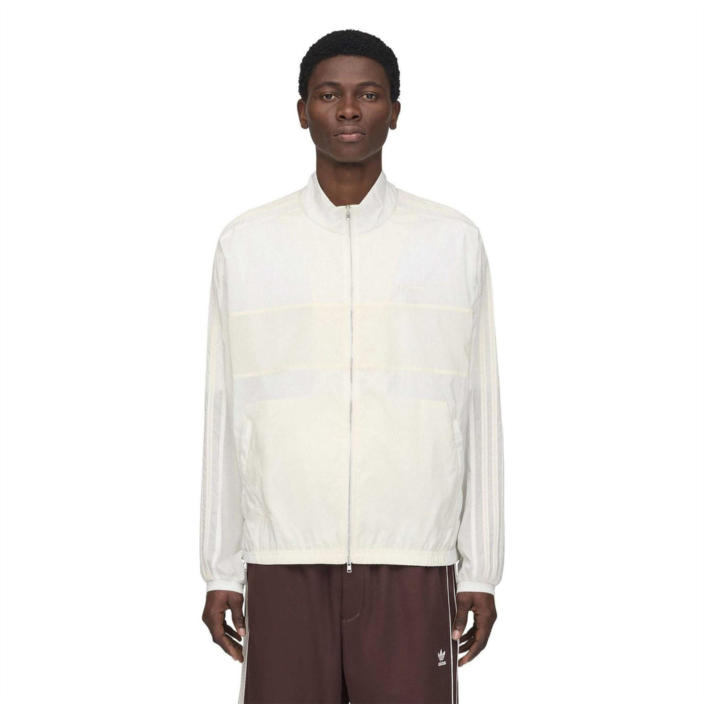 Chalk white track jacket front with stand collar, full zip, and elastic cuffs.