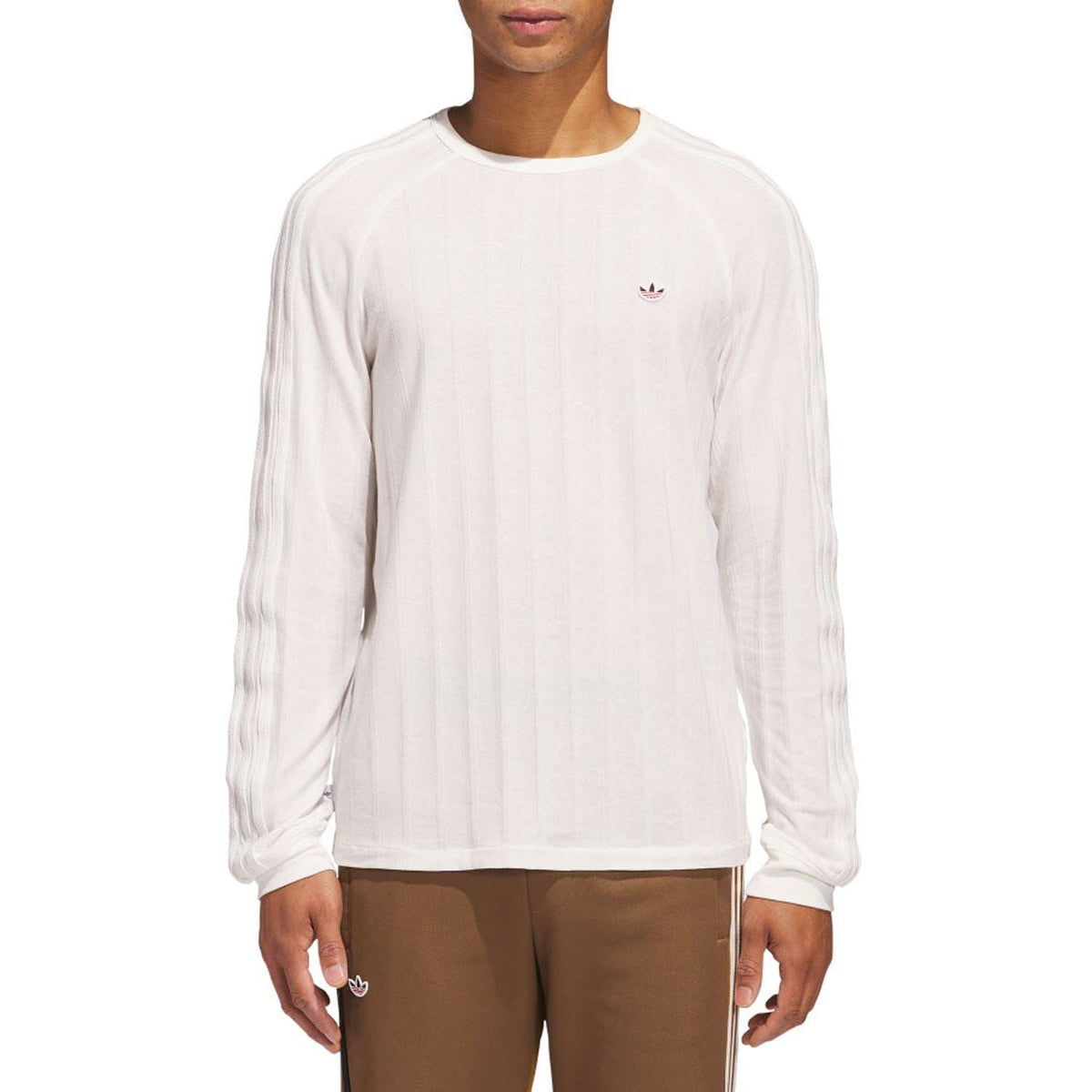 White ribbed long-sleeve crewneck t-shirt with small chest logo on model