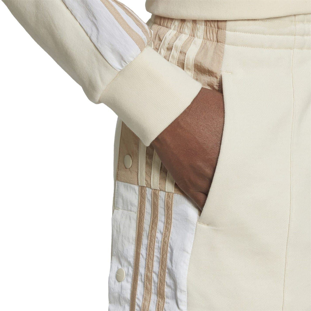 Light mini skirt detail with striped panel, snap buttons, and elastic waistband