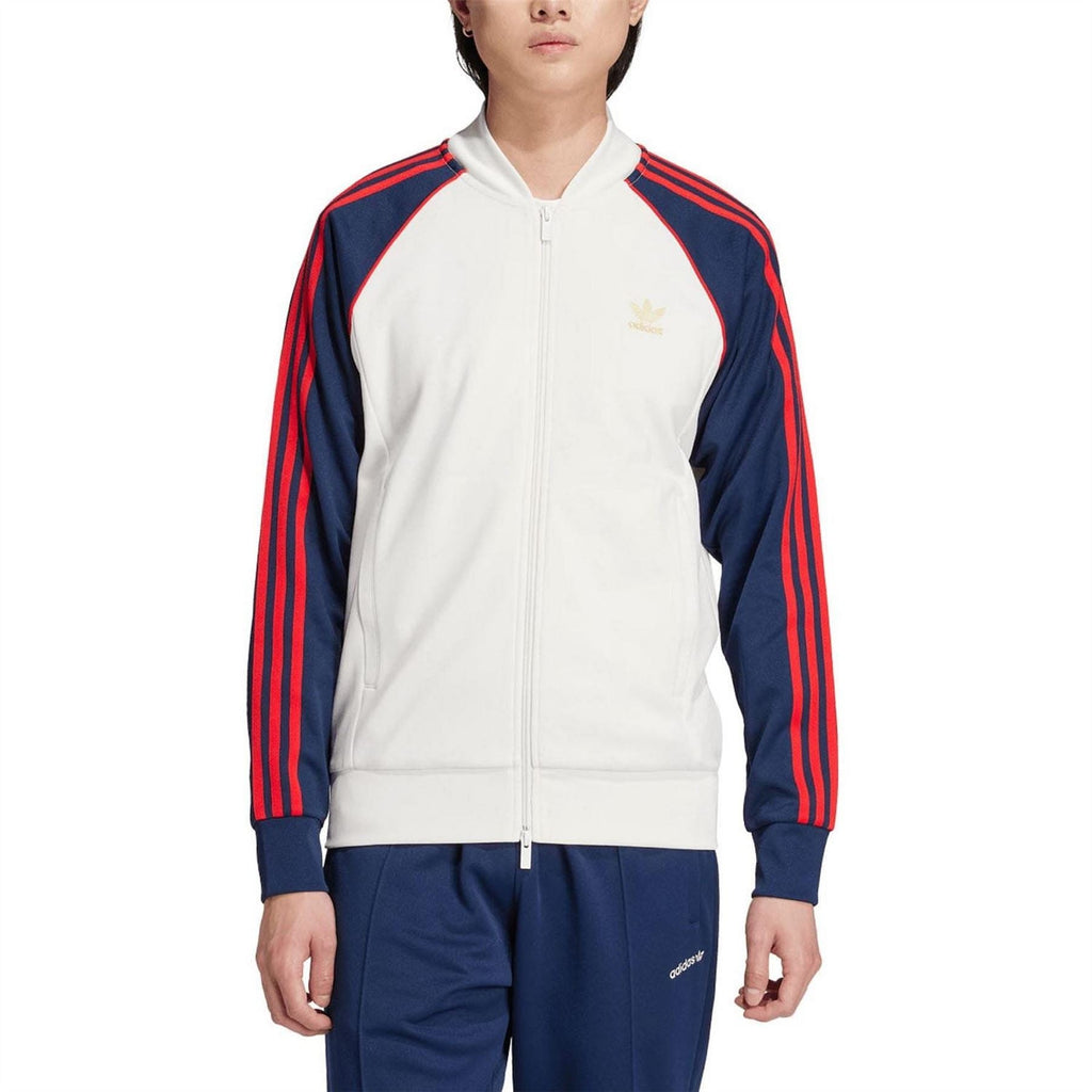 White track jacket with full zip and navy/red stripe sleeves; adidas logo on chest