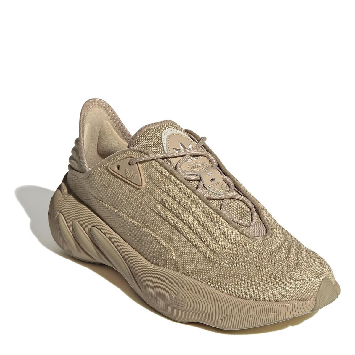 Beige lace-up low-top trainers with mesh texture and sculpted midsole