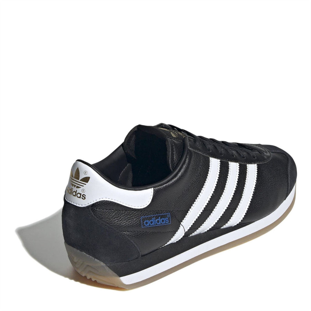 Black low-top sneakers with white heel tab and triple stripes, lace-up style.