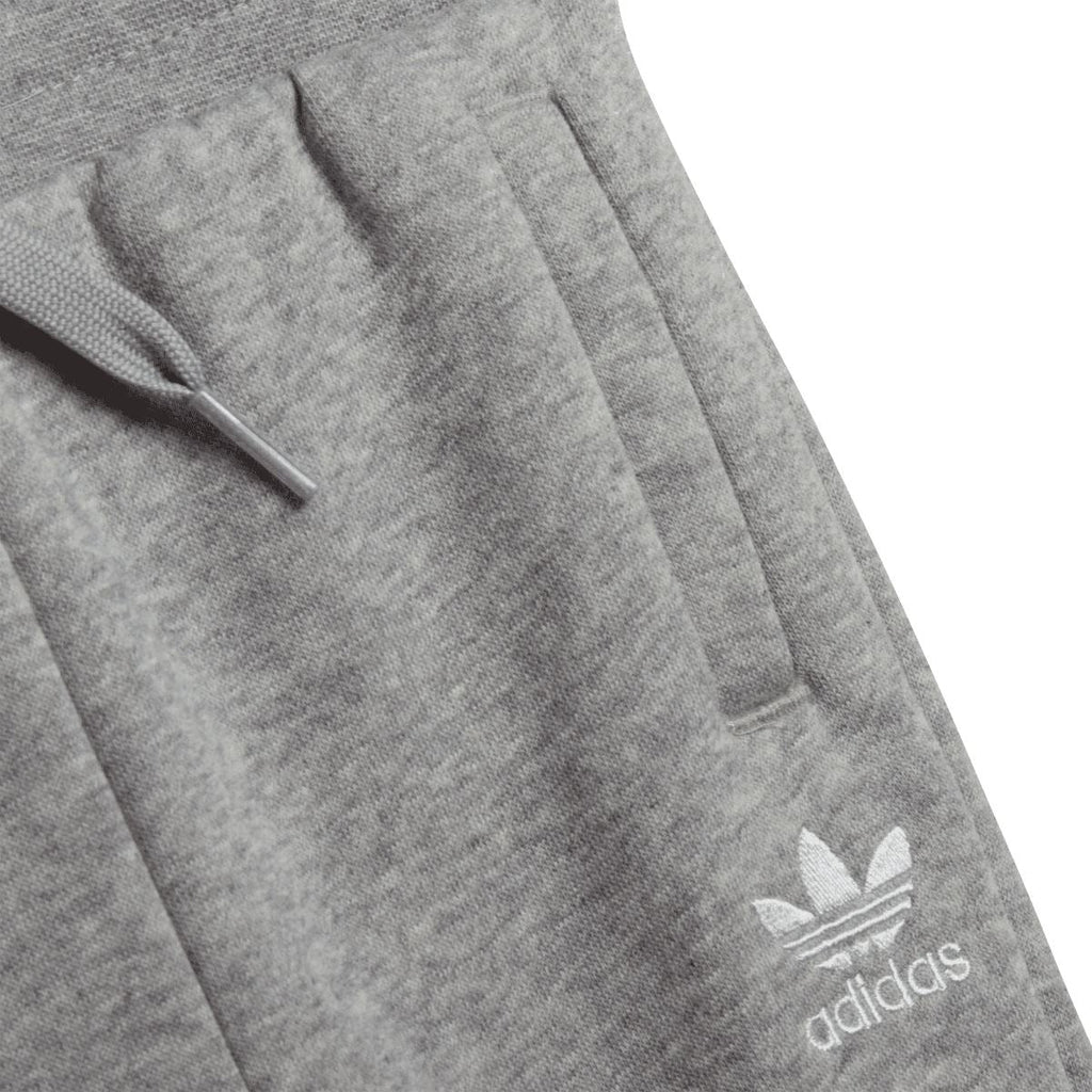 Grey infant jogger pants close-up with adidas logo on thigh pocket.