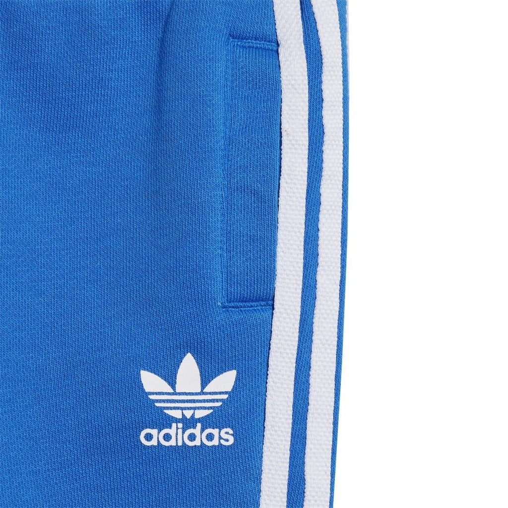 Infant blue jogger pants with white adidas logo and side stripe detail
