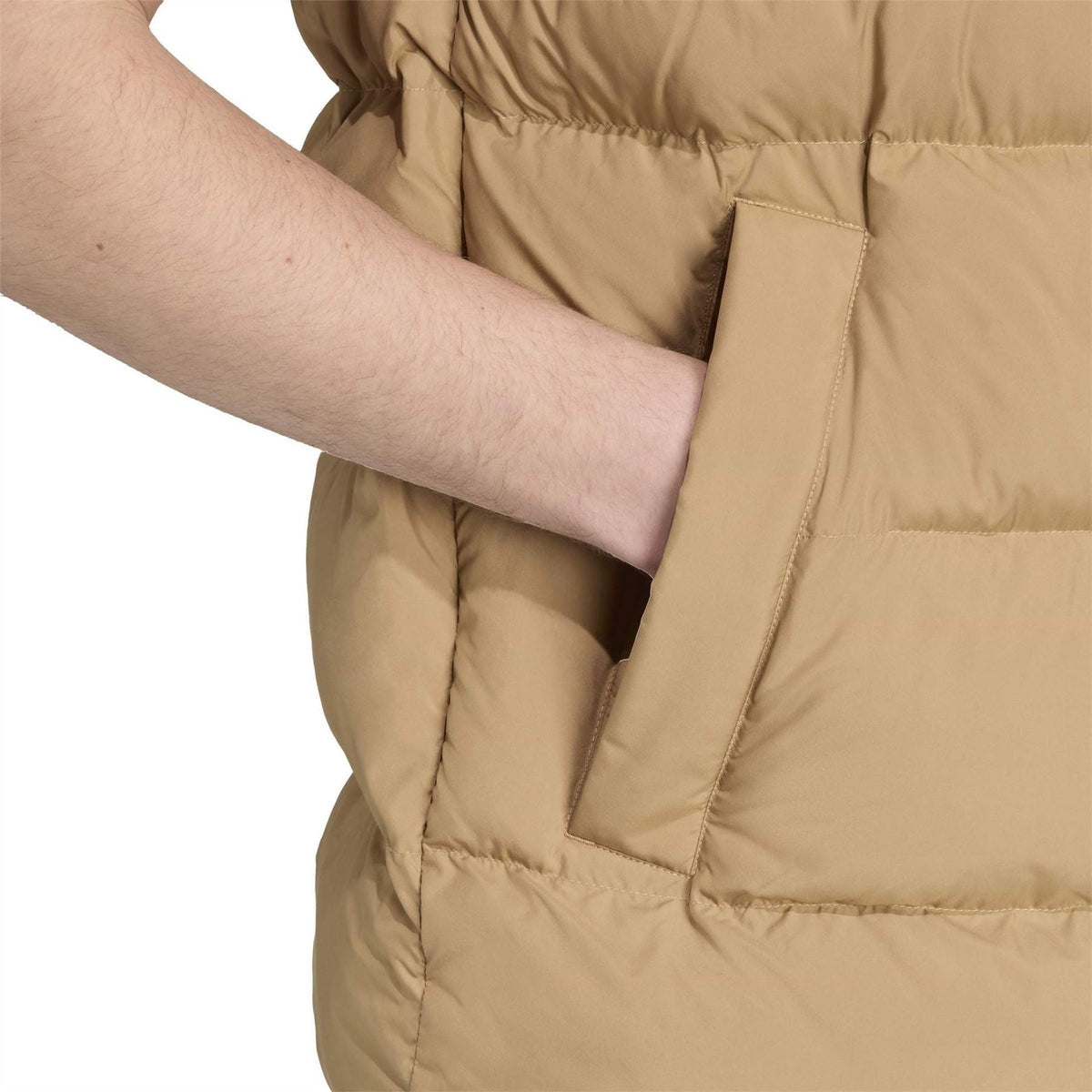 Tan puffer vest detail: vertical welt pocket and close front quilting