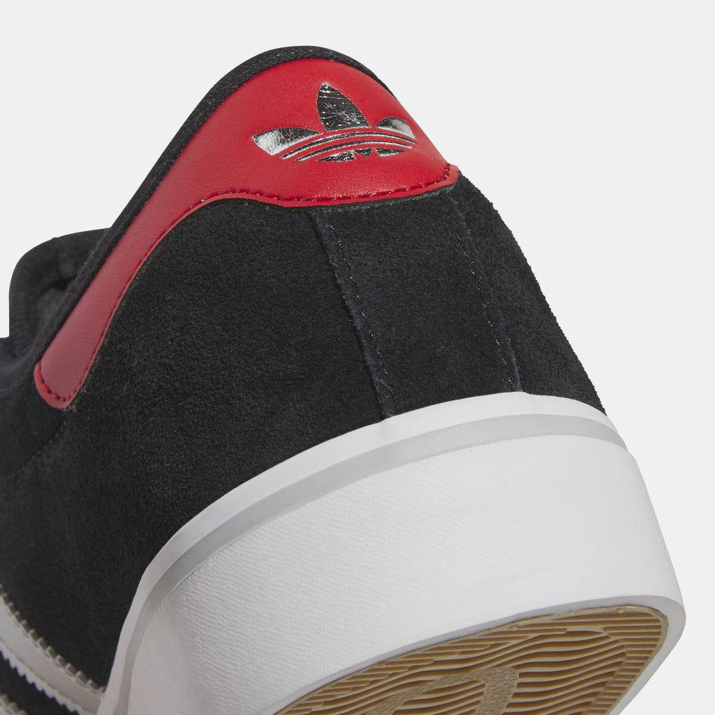 Close-up of adidas Originals Adi Ease black suede heel with red overlay and trefoil logo