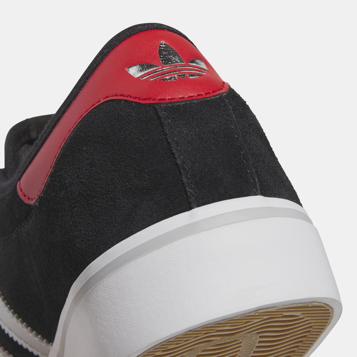 Close-up of adidas Originals Adi Ease black suede heel with red overlay and trefoil logo